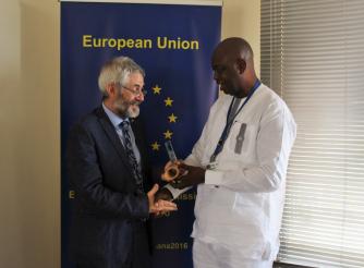 Sumaila Abdul-Rahman, Country Director of ActionAid Ghana receives the Overall Award for Video Most Appealing to the European Public from Paolo Salivia, the Chargé d’Affaires of the European Union in Ghana